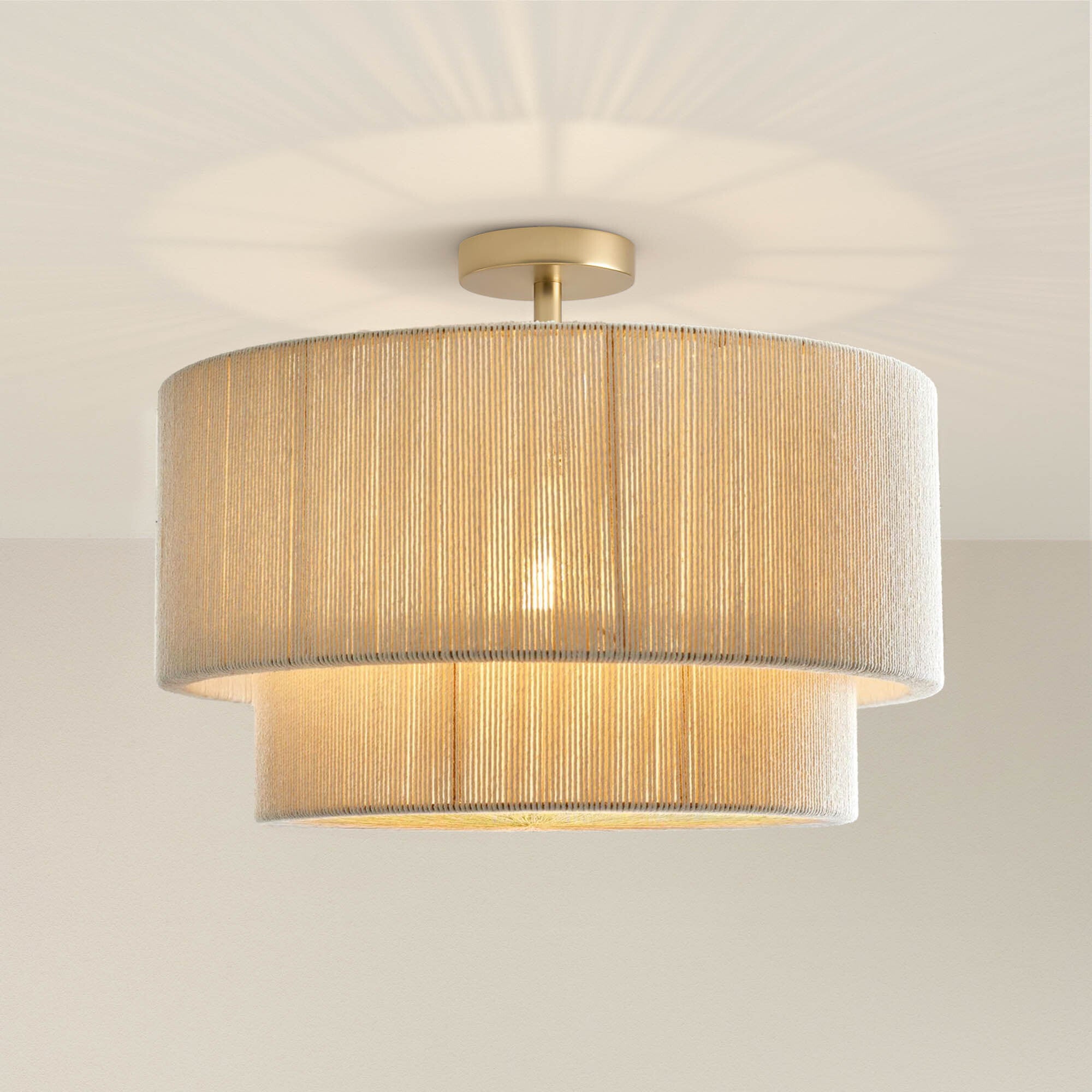 elaine rattan flush mount ceiling light fixture with a textured beige shade