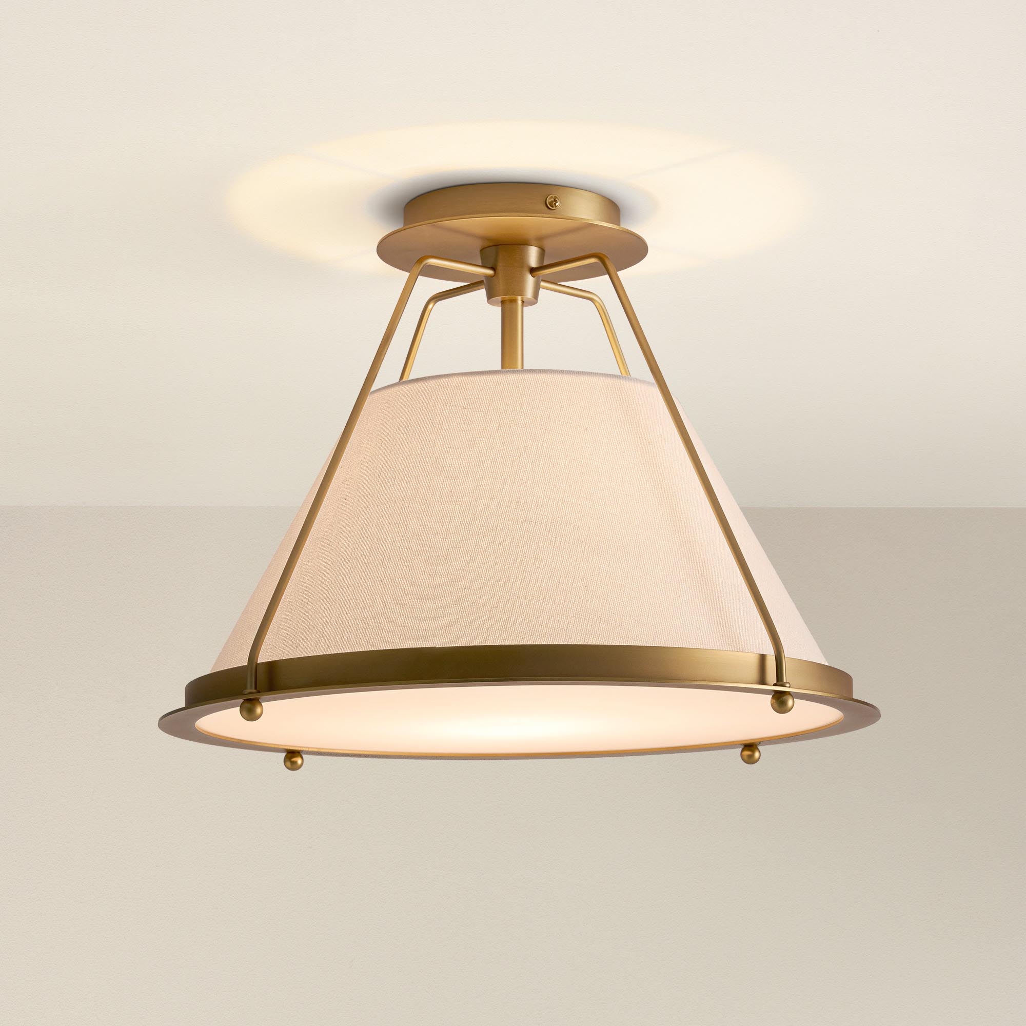 solace flush mount ceiling light fixture with gold frame and white shade, on